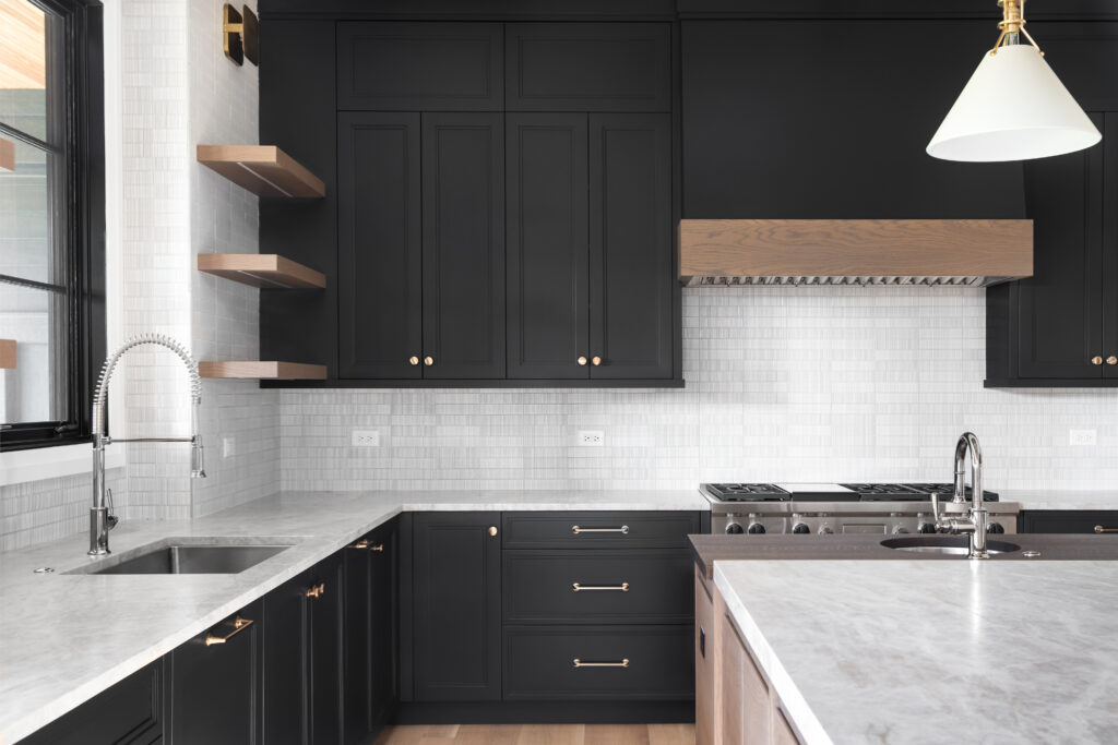 A black kitchen with stainless steel appliances. cabinet painting